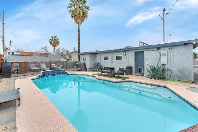 view of swimming pool featuring a patio area, fence, and a fenced in pool