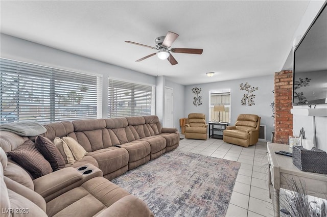 living area with light tile patterned floors and ceiling fan