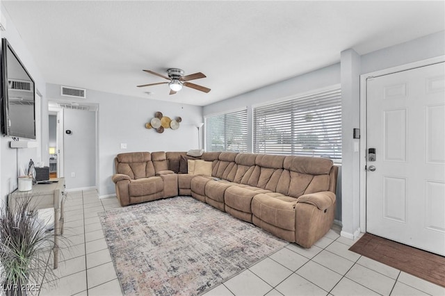 living area with a ceiling fan, visible vents, baseboards, and light tile patterned floors