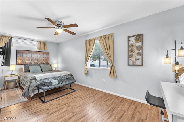 bedroom featuring wood finished floors, a ceiling fan, and baseboards