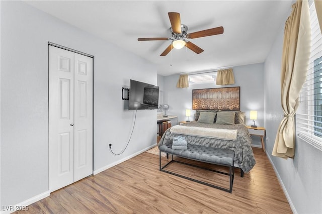 bedroom featuring a closet, ceiling fan, baseboards, and wood finished floors