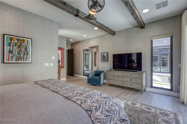 bedroom featuring light wood-type flooring and beamed ceiling