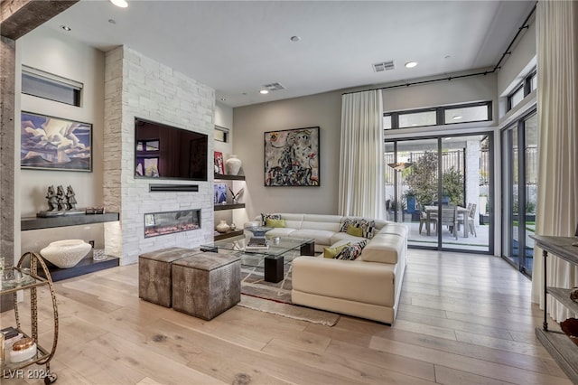 living room featuring a fireplace and light hardwood / wood-style floors