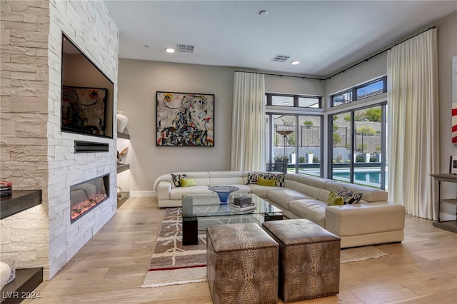 living room featuring a fireplace and light hardwood / wood-style flooring