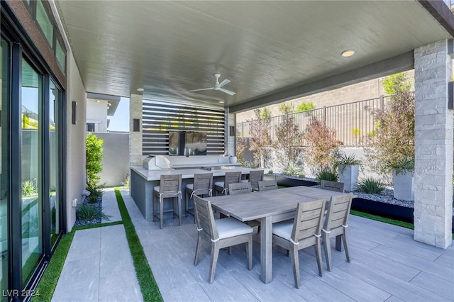 view of patio / terrace featuring exterior kitchen and ceiling fan