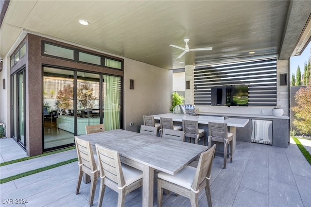 view of patio with ceiling fan and an outdoor kitchen