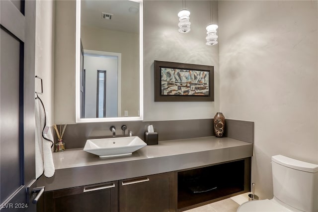 bathroom with toilet and vanity