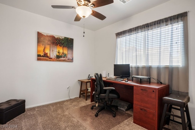 carpeted office space with ceiling fan