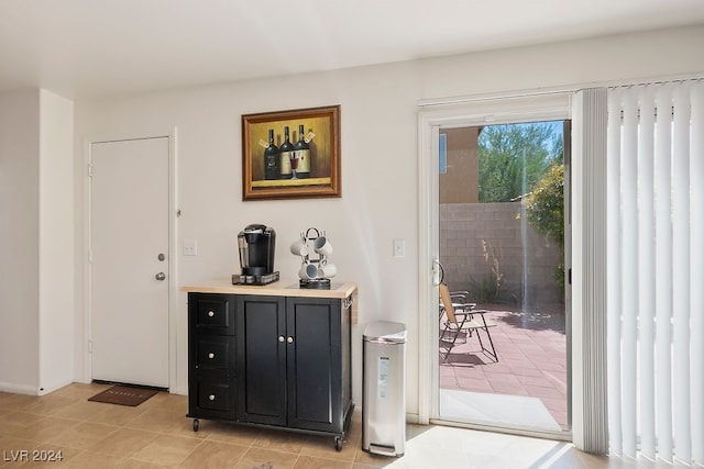 doorway to outside featuring light tile patterned floors