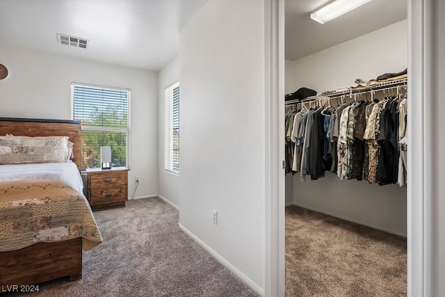 bedroom featuring light carpet and a closet