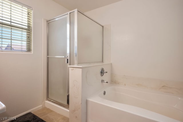 bathroom with separate shower and tub and tile patterned flooring