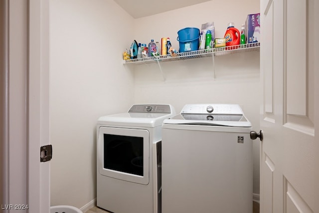 clothes washing area with washing machine and clothes dryer