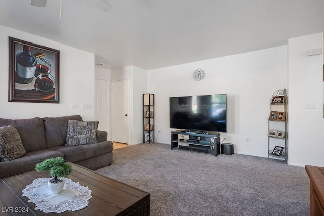 carpeted living room with ceiling fan