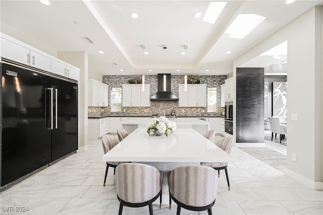 dining space featuring a raised ceiling