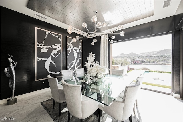 dining room with plenty of natural light, an inviting chandelier, and a mountain view