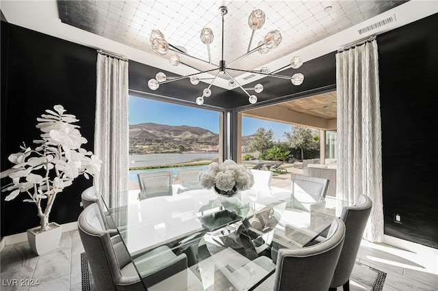 dining room featuring a mountain view and a chandelier