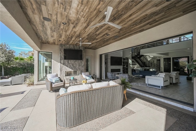 view of patio with an outdoor living space and ceiling fan