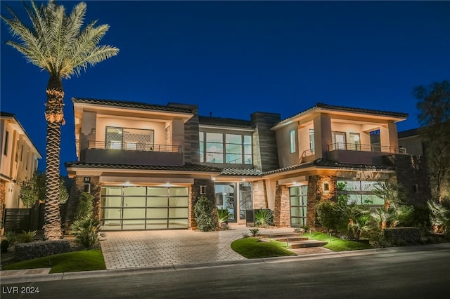 view of front of home with a balcony and a garage