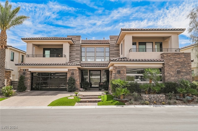 mediterranean / spanish-style home featuring a balcony and a garage