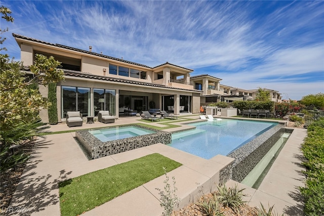 view of pool with a patio and an in ground hot tub