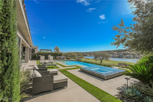 view of swimming pool featuring a water view, a patio, and an in ground hot tub