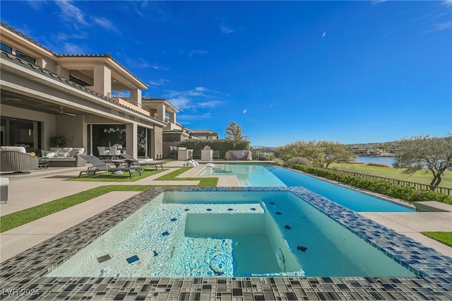 view of pool with a water view, an in ground hot tub, a patio area, and outdoor lounge area