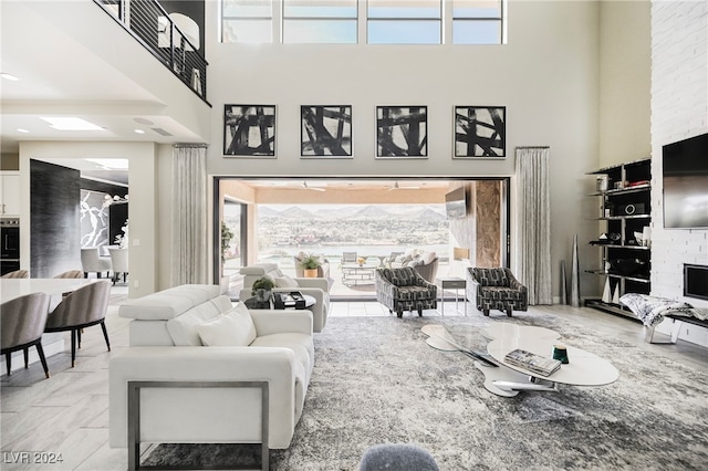 living room featuring a towering ceiling and a healthy amount of sunlight