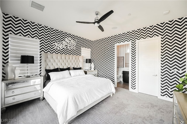 carpeted bedroom with connected bathroom and ceiling fan