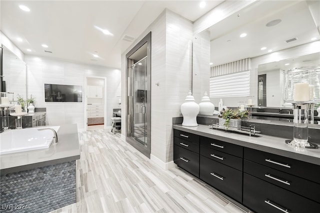 bathroom featuring vanity, wood-type flooring, and plus walk in shower