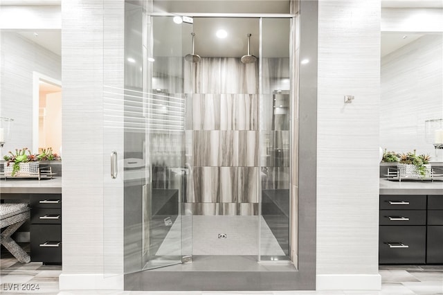 bathroom featuring tile walls, an enclosed shower, and vanity