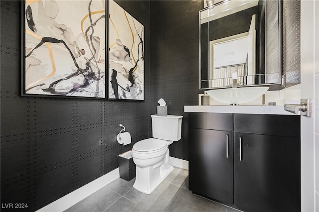 bathroom with vanity, toilet, and tile patterned floors