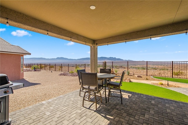 view of patio / terrace featuring a mountain view and a grill