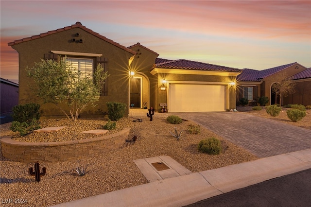 mediterranean / spanish-style home with a garage