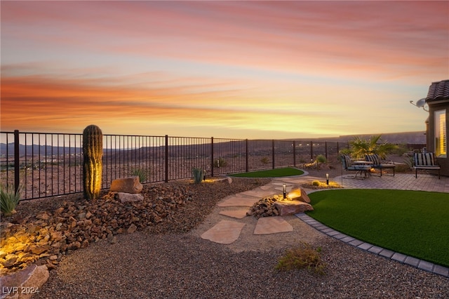 yard at dusk with a patio