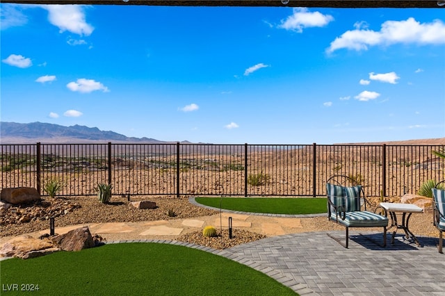 view of yard with a mountain view and a patio area