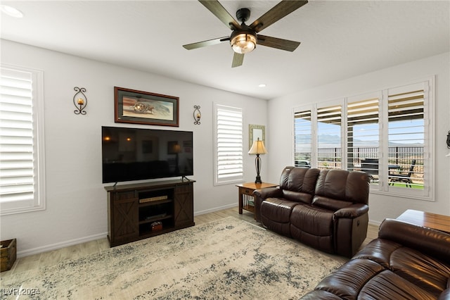 living room with light hardwood / wood-style floors and ceiling fan