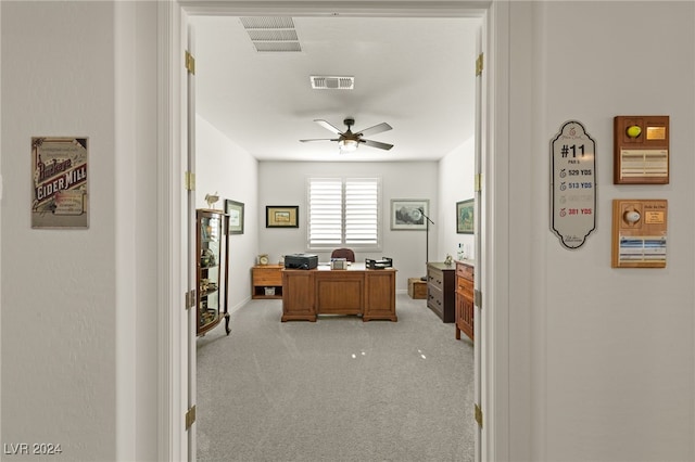 home office featuring light colored carpet and ceiling fan