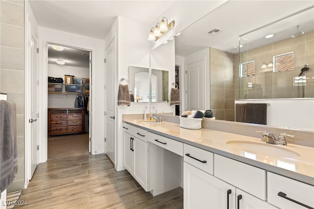 bathroom featuring vanity and a shower