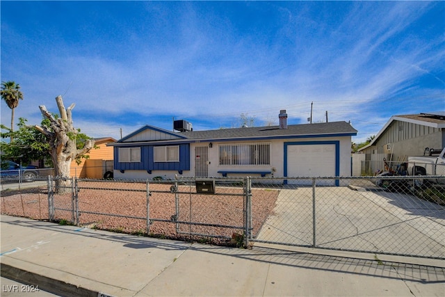 view of front facade with a gate, stucco siding, concrete driveway, a garage, and a fenced front yard