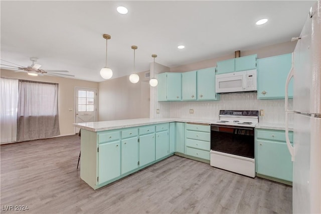 kitchen with light wood finished floors, white appliances, light countertops, and a peninsula