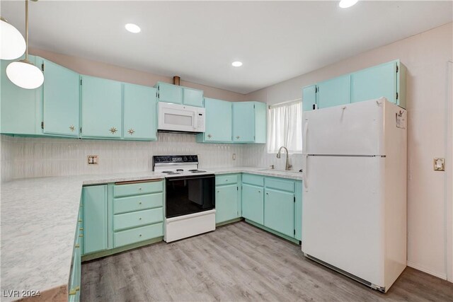 kitchen featuring tasteful backsplash, white appliances, sink, light hardwood / wood-style floors, and hanging light fixtures