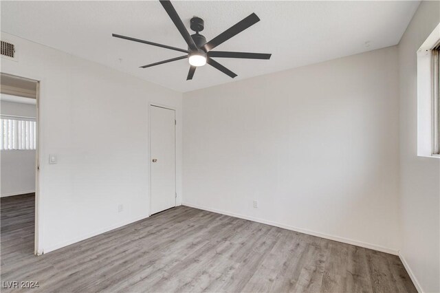 unfurnished room with ceiling fan and light hardwood / wood-style flooring