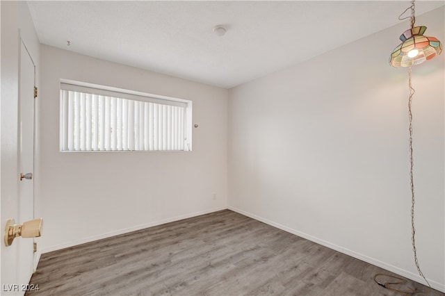 unfurnished room with wood-type flooring