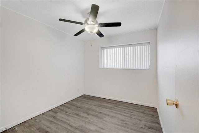 spare room with a ceiling fan, baseboards, and wood finished floors