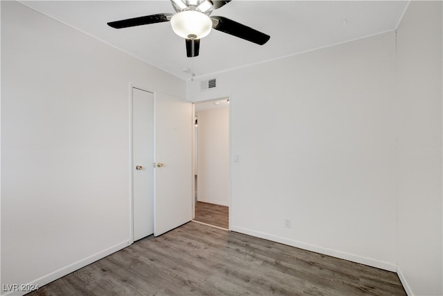 spare room with ceiling fan and light wood-type flooring