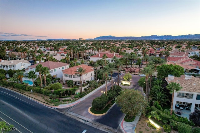 aerial view at dusk featuring a mountain view