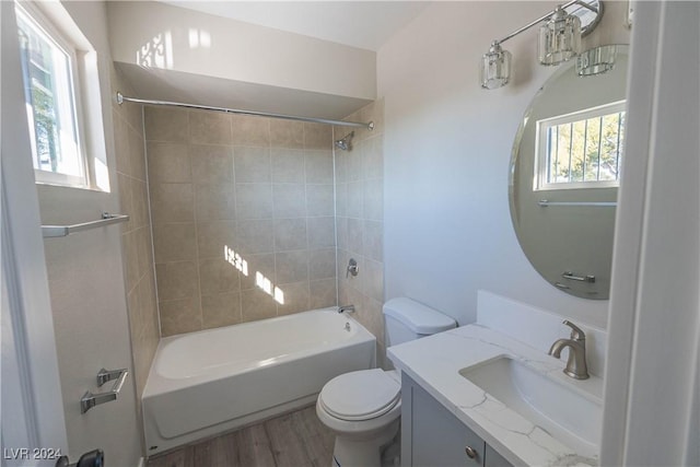 bathroom featuring tub / shower combination, vanity, toilet, and wood finished floors