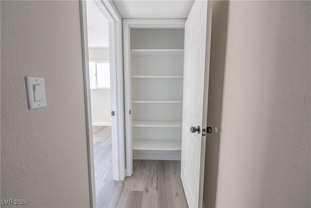 corridor featuring light hardwood / wood-style floors