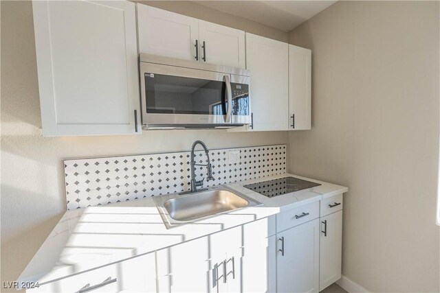 kitchen with sink and white cabinetry