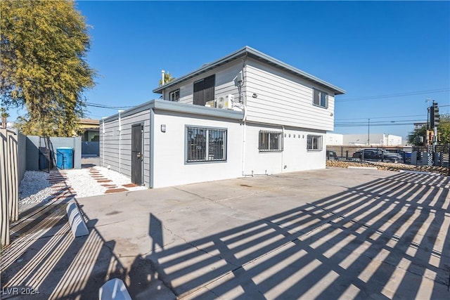 rear view of house featuring a fenced backyard and a patio